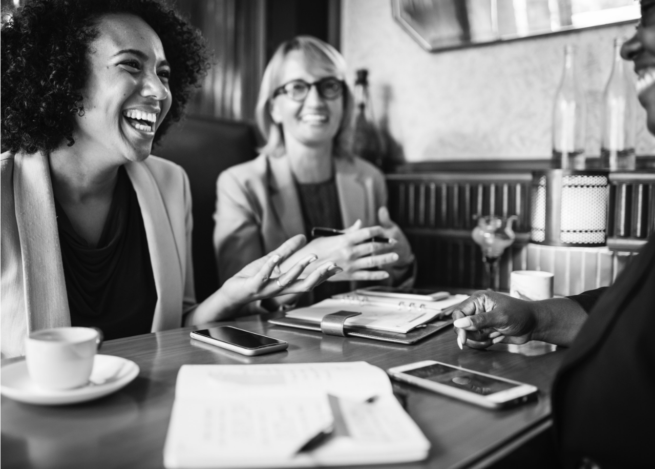 women laughing in boardroom